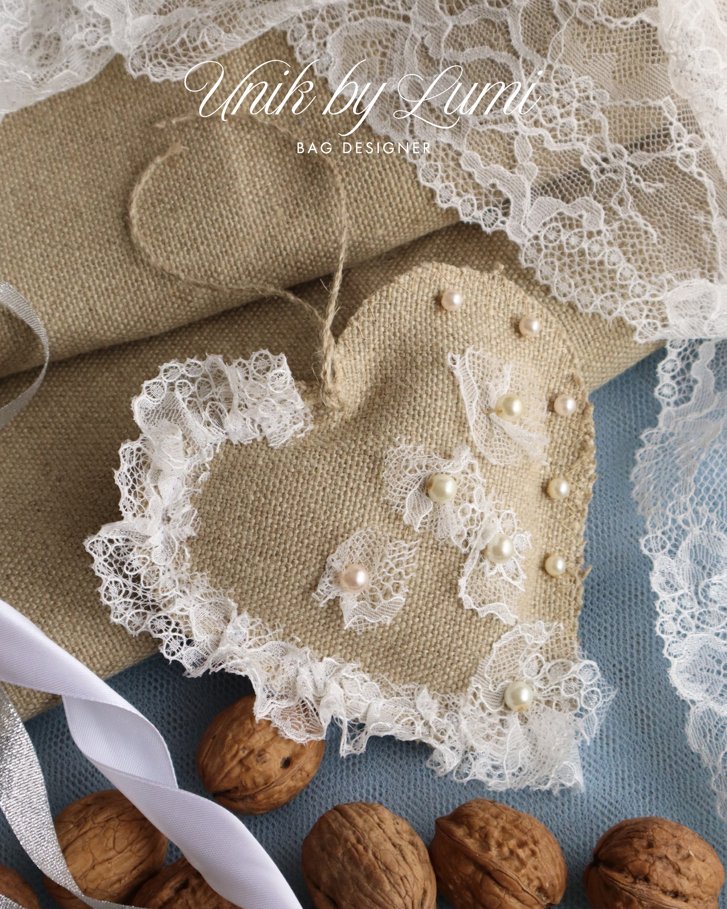 Decorative item with lace and pearls on a textured surface with nuts.
