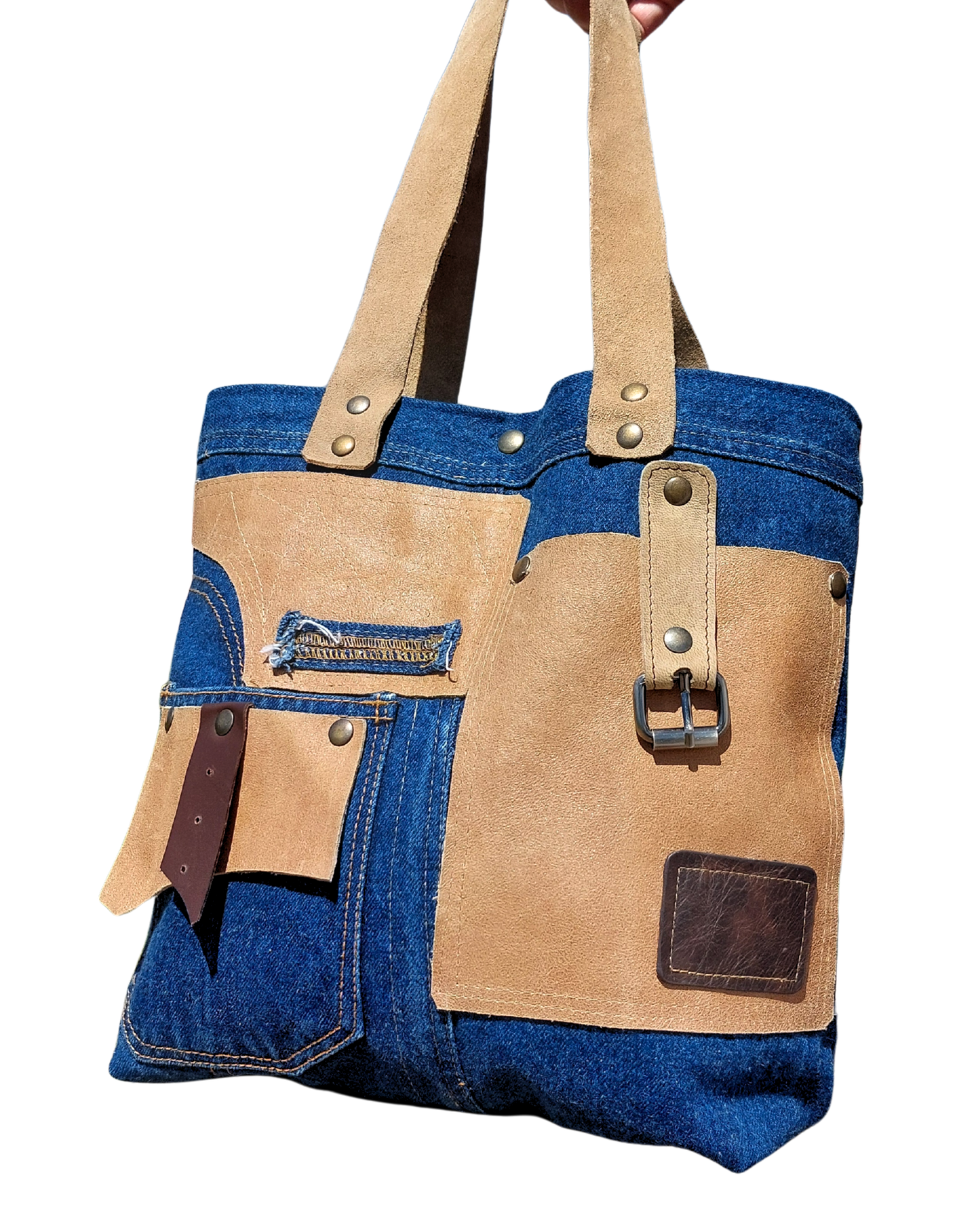 Tote bag with denim and brown leather sections on a white background