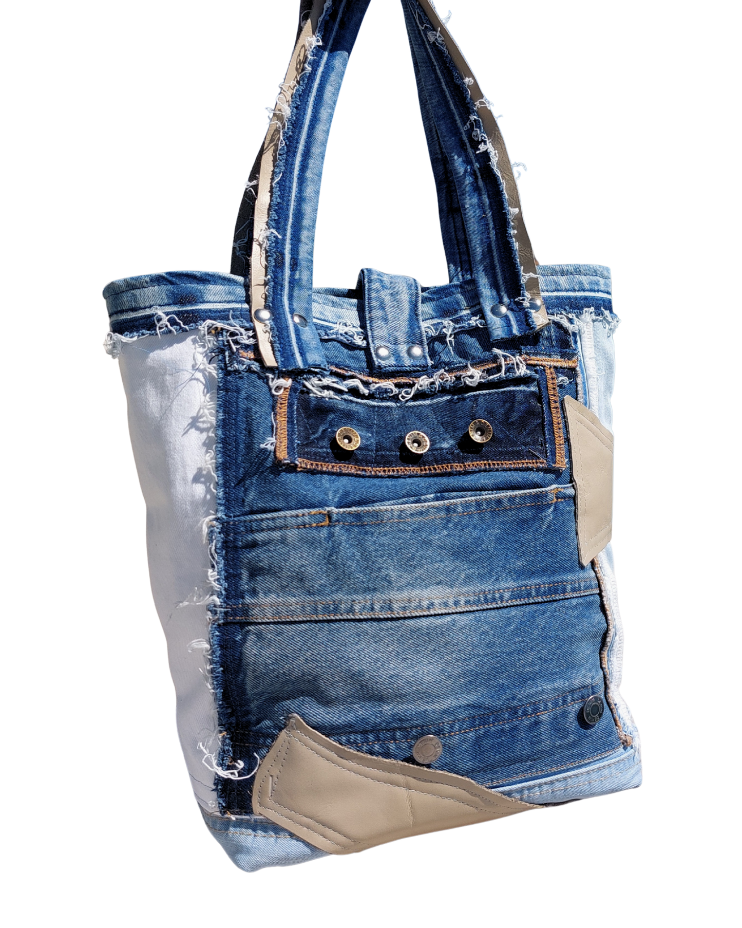 Denim tote bag with leather details on a white background